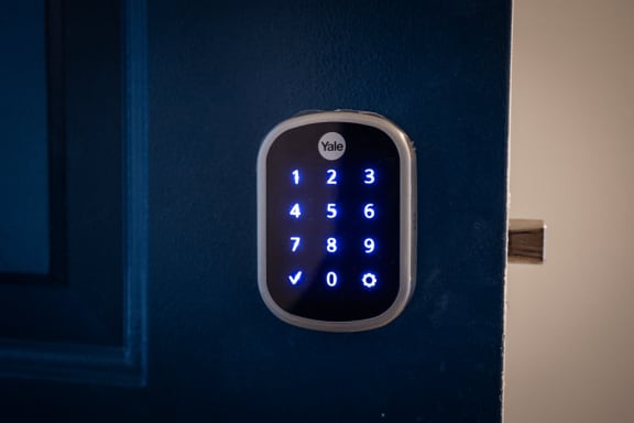 a blue door handle with a lit up clock on it  at Signature Pointe Apartment Homes, Athens, AL