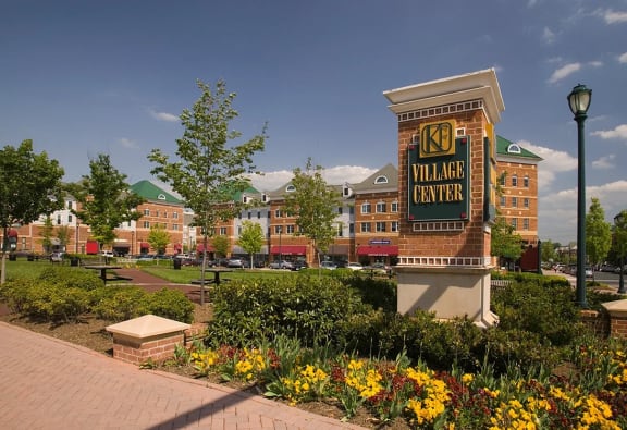 a large brick building with a sign on top of it at The Residences at King Farm, Rockville, 20850