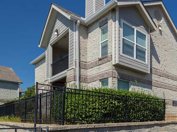 The exterior of Hawthorne Apartment Homes, featuring a well-kept building with lush landscaping.
