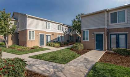 A sunny day at a residential area with houses and green lawns.