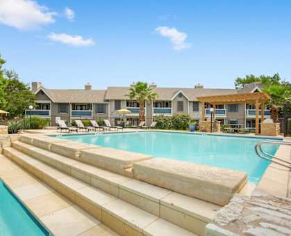 A large swimming pool with steps leading into it.