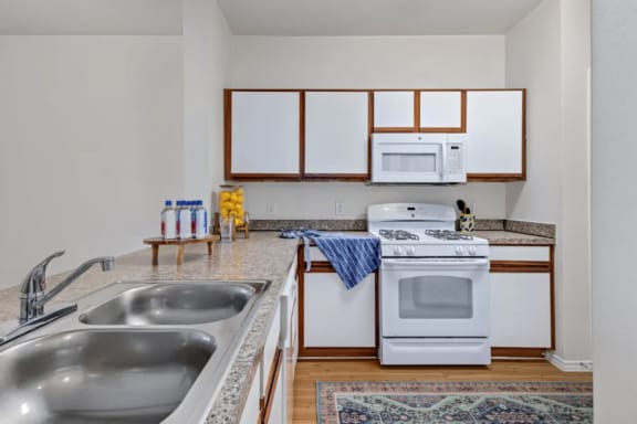 a kitchen with a sink stove and microwave at Mariposa at Bay Colony, Dickinson, 77539