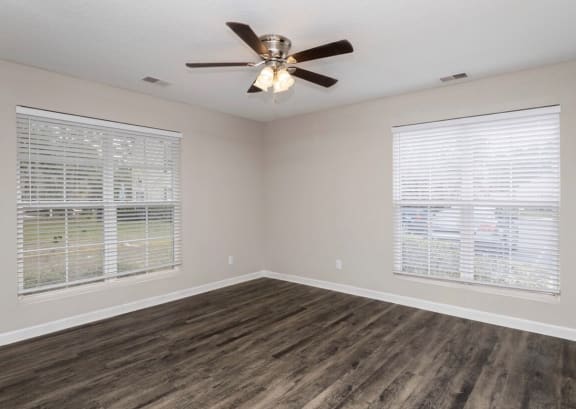 A room with a ceiling fan and wood flooring at Diamond Townhomes, Beaufort, SC 29906