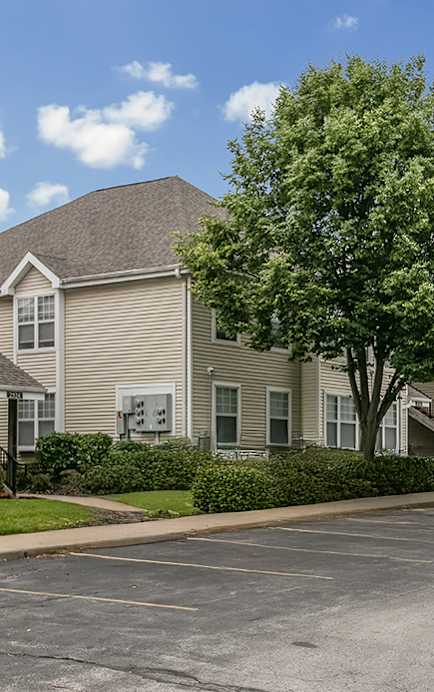 a row of houses with a sidewalk in front of them
