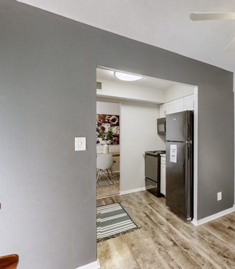 a living room with a kitchen and a ceiling fan at Halsey Flats, Louisville, KY, 40207