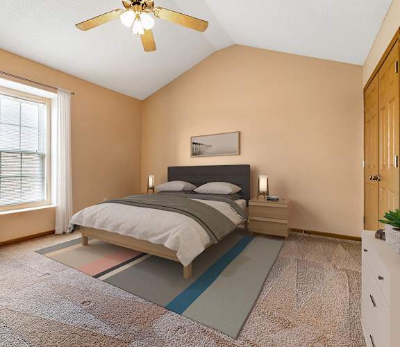 A bedroom with a bed, nightstand, and window.