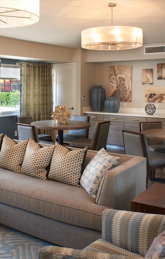 A spacious room with a ceiling fan and wooden flooring.