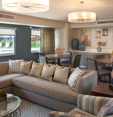 a living room with couches and chairs and a dining table