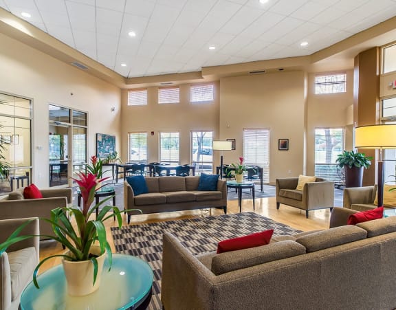 a lobby with couches and chairs and a table