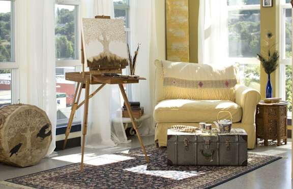 a living room filled with furniture and a large window