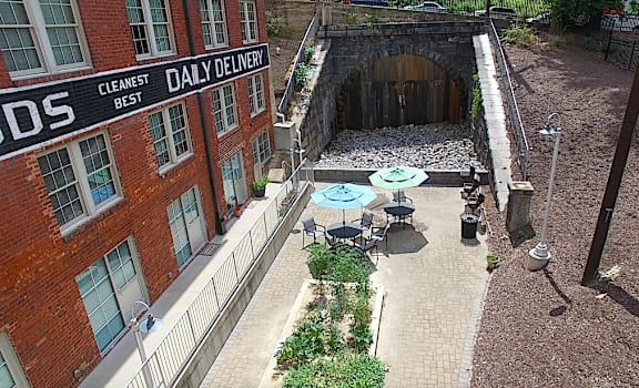 an overhead view of a courtyard with tables and a building