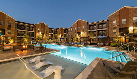Community Swimming Pool with Pool Furniture at Alta 3Eighty Apartments located in Aubrey, TX-LRGAM.