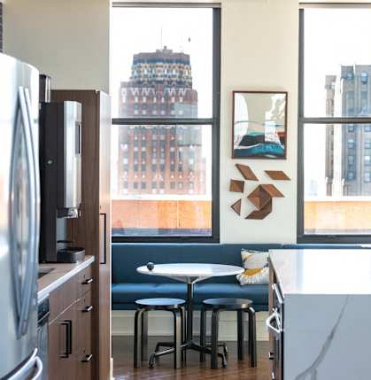 a kitchen and living room with a view of the city