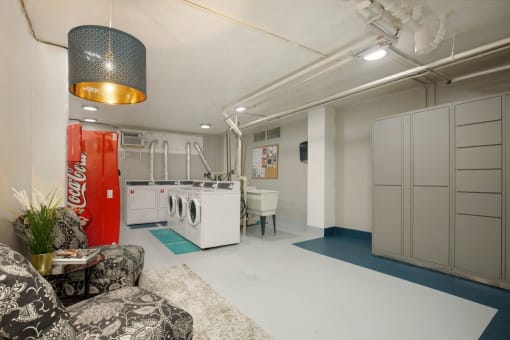 Fun and Cozy Laundry Room with comfy seating area at Stockbridge Apartment Homes, Seattle, WA