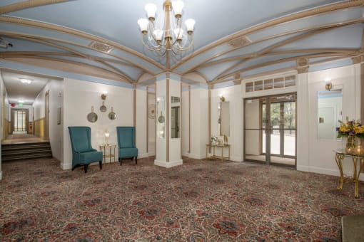 Lobby with Blue Painted Ceiling, Detailed Molding Work, Large Chandeliers, and Patterned Carpeting at Stockbridge Apartment Homes, Seattle, 98101