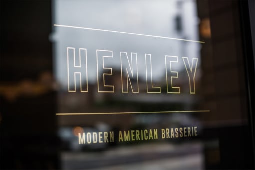 a logo is pictured on the front door of a modern american brasserie restaurant in san at Aertson Midtown Apartments, 905 20th Avenue South, Nashville