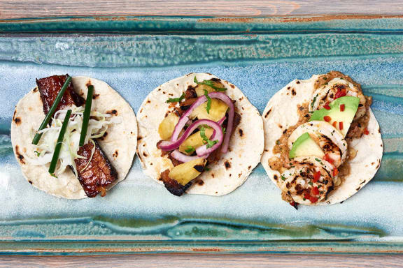 a trio of tacos on a tray at Aertson Midtown Apartments, 905 20th Avenue South, Nashville