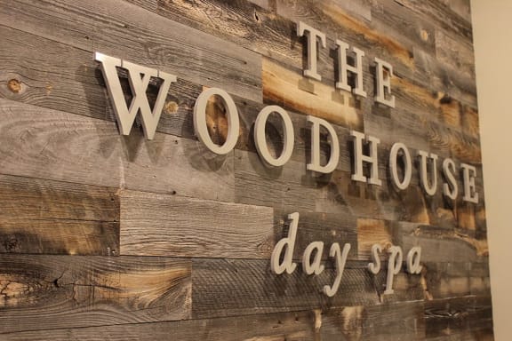 a reclaimed wood sign that reads the woodhouse day spa at Aertson Midtown Apartments, 905 20th Avenue South, Nashville