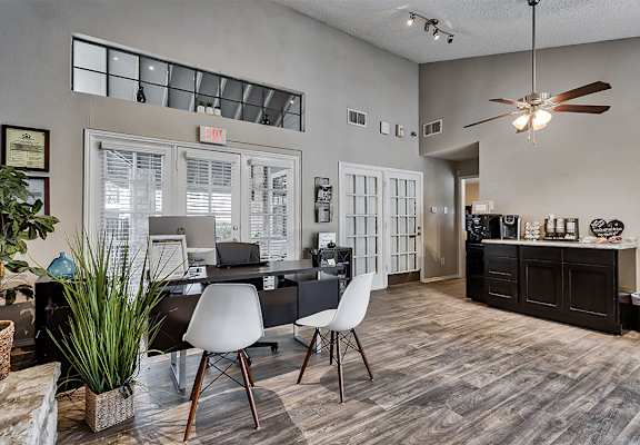 an office with a desk and chairs and a ceiling fan at The Broadwater at Salado Creek, San Antonio, Texas