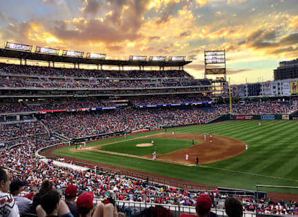A baseball game is being played in a packed stadium.