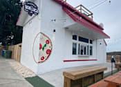 Thumbnail 2 of 7 - A white building with a red roof and a sign that says "Don Luca" on it.