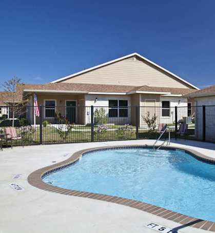 a swimming pool in front of a house