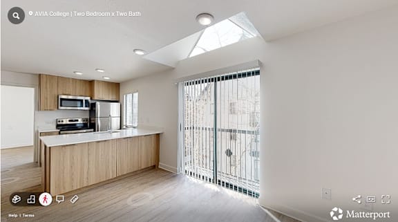 A modern kitchen with wooden cabinets and a skylight.