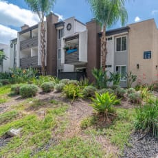 a house with a sidewalk and plants in front of it at City View Apartments at Warner Center, Woodland Hills