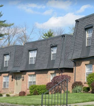 a white house with a driveway and a garage door