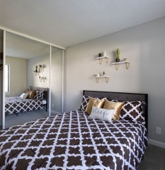 a bedroom with a black and white bed at Diablo Vista Apartments, Livermore, CA, 94551