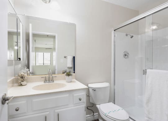 a white bathroom with a shower sink and toilet at Huntington Terrace North Senior, Huntington Beach, 92648