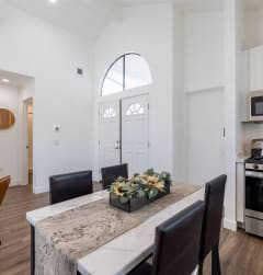a kitchen and dining room with a table and chairs at Diablo Vista Apartments, Livermore, CA
