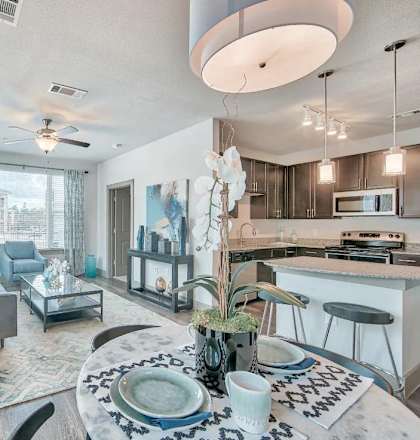 an open living room and kitchen with a dining table