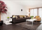 Thumbnail 4 of 7 - a living room with a brown couch and a white table