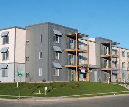 Image of outside corner of the building showing the road and some decks