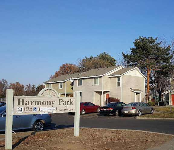 the facade of a building with a driveway and a gate