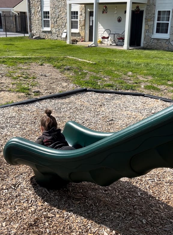 a young boy in a pool with a life jacket
