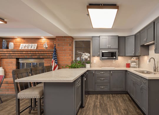 a kitchen with gray cabinets and a white counter top at Huntington Terrace North Senior, Huntington Beach, 92648