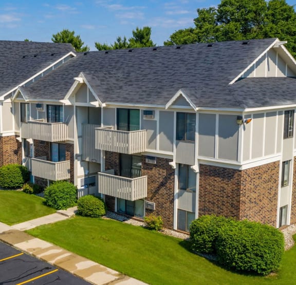 apartments with balconies on the side of a brick building at Hickory Village Apartments, Mishawaka, IN