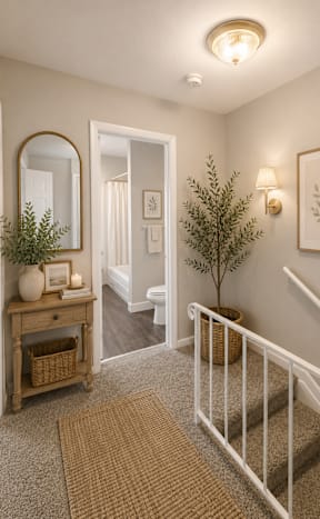 a living room with a white couch with pillows and a green blanket at Colony Townhomes, Raleigh