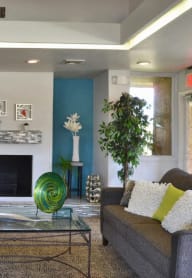 a living room with tables and chairs and a tv