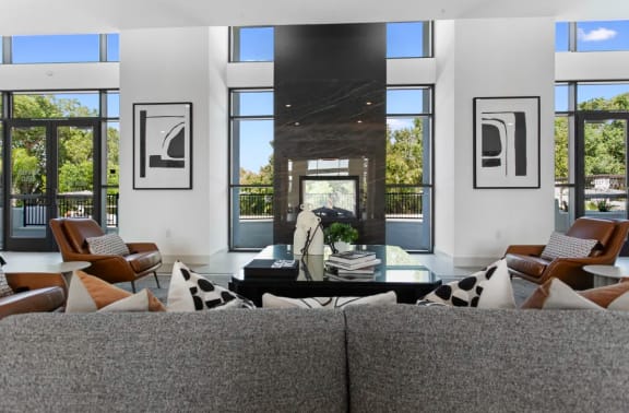 a living room filled with furniture and a large fireplace at The Venue at Orange Apartments, California