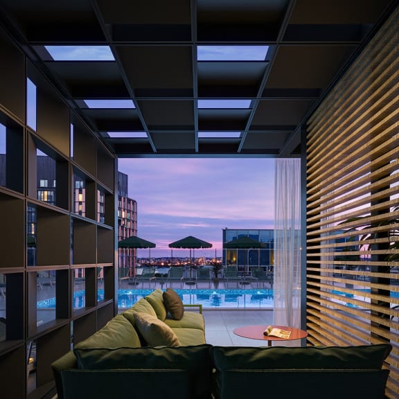 a living room with a couch and a view of a swimming pool