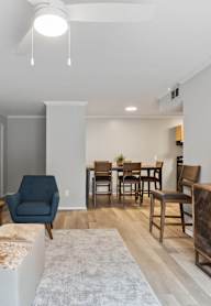a living room and dining room with a table and chairs