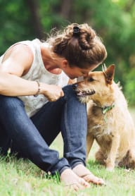 a woman sitting on the grass with her dog at Madison Rockwood, MO