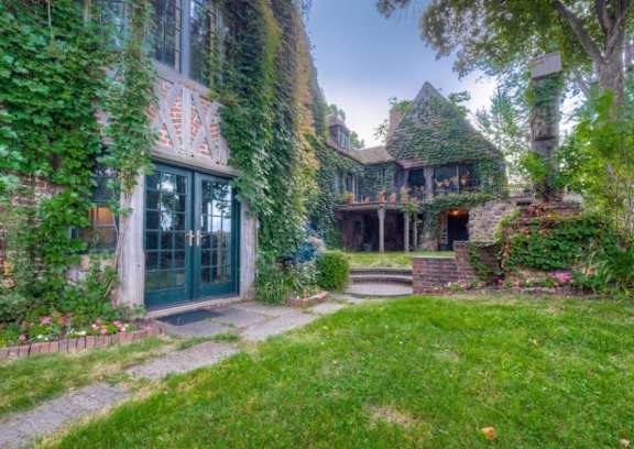 A house with a green door and a garden in front at The Barnum Apartments, White Bear Lake, 55110