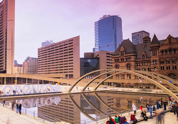 A large building with a dome and a bridge over a body of water.