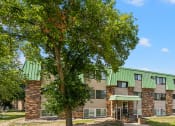 Thumbnail 22 of 22 - a building with green roofs and a tree in front of it