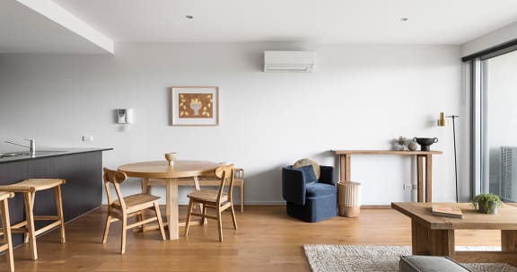 a living room and dining area with a table and chairs