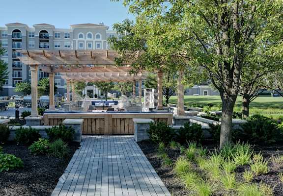 Walkway and garden leading to covered patio area at The Mil'Ton in Vernon Hills, IL